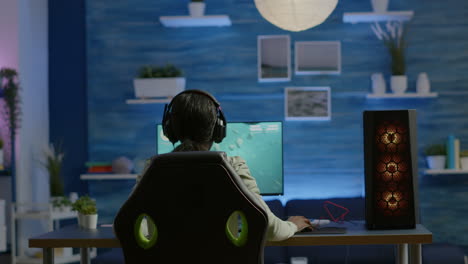 african player sitting on gaming chair with headset