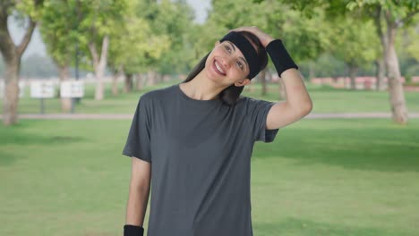 happy indian girl doing neck stretching