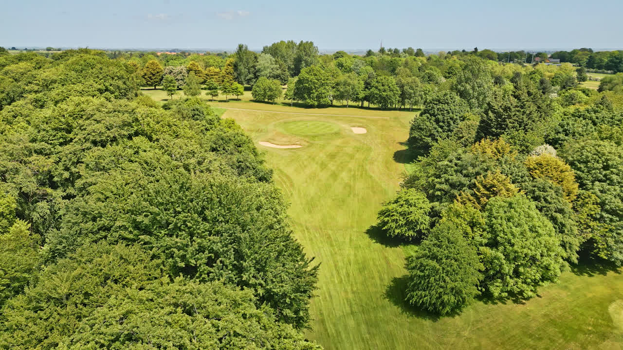 Captured by drone: a UK Golf Course &mdash; people enjoying a meandering stream, charming picnic areas, and wooded tourist attraction