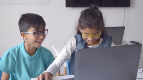 Couple-of-excited-classmates-working-on-task