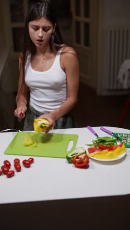 woman chopping vegetables in kitchen