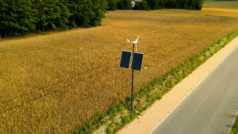 Wind-generator-with-solar-panel-near-the-golden-ripe-wheat-field-in-countryside-Czeczewo,-Poland