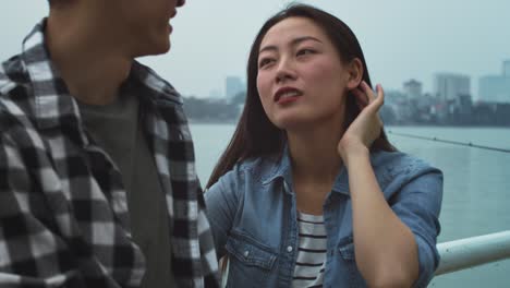 handheld view of vietnamese woman talking with her boyfriend