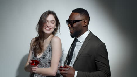 Glamorous-Multiethnic-Couple-Smiling-and-Posing-with-Drinks