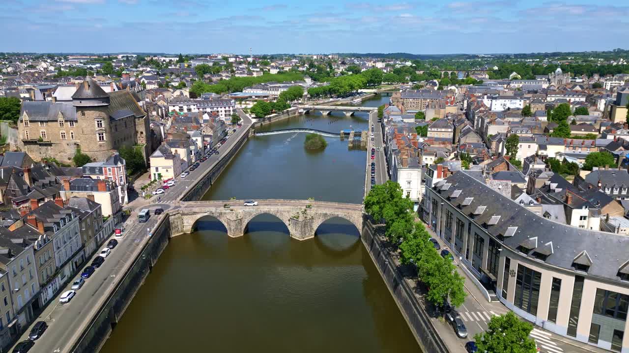 Sideways drone flight over Mayenne River, two bridges, Laval Castle, and city center with pivoting aerial view - France