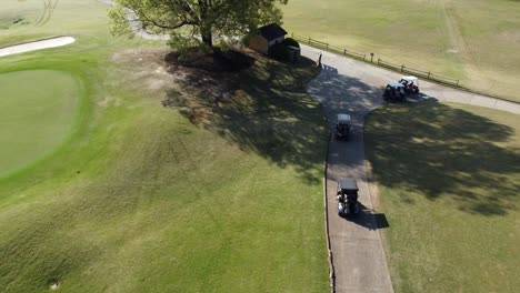 drone flies over golf course and golf carts