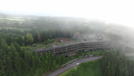 Abandoned-hotel-Monte-palace-at-São-Miguel-during-a-cloudy-day,-aerial