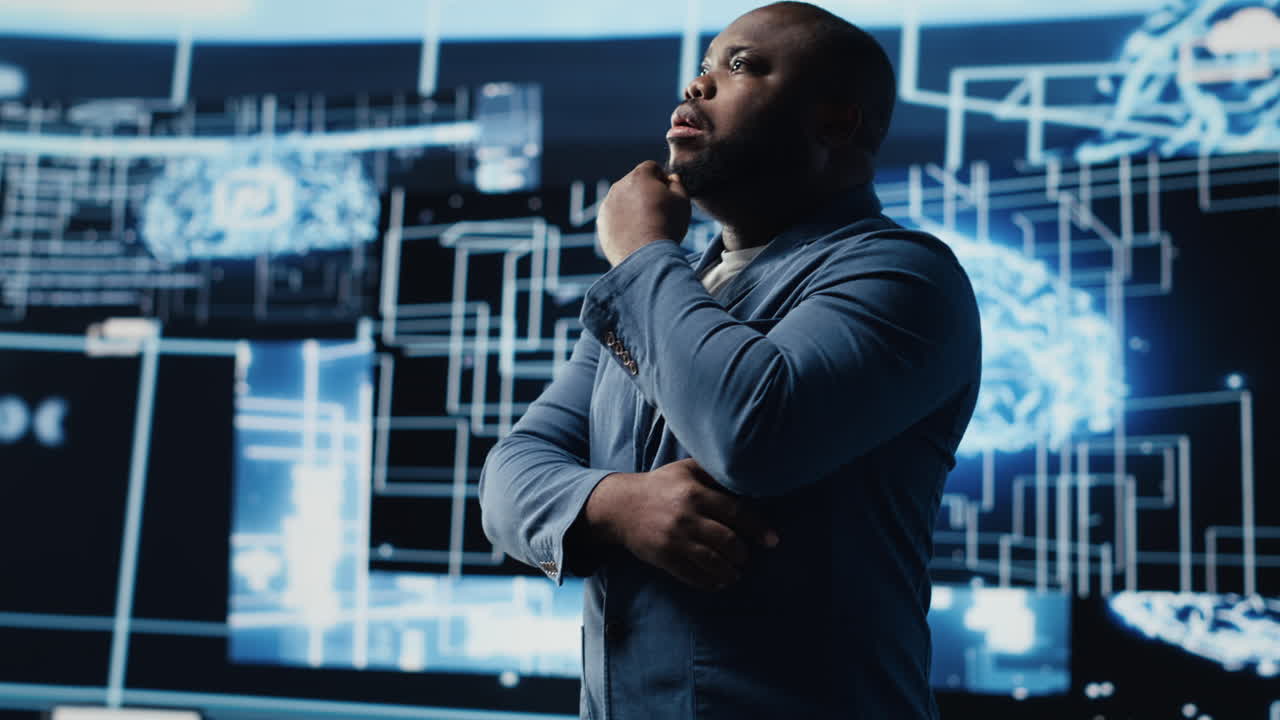 Black male specialist engaged in AI research interacting with data structures