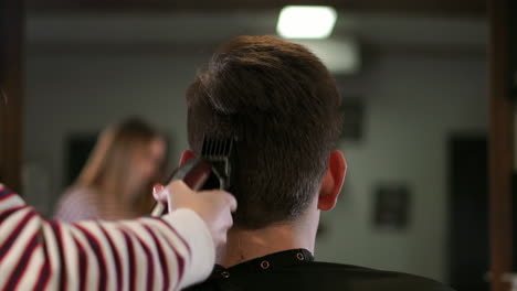 man having a haircut with a hair clippers