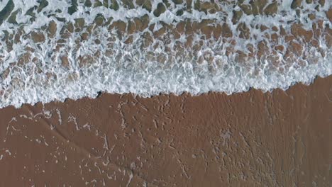 AERIAL-DIRECTLY-ABOVE-Ocean-Waves-Rolling-Into-Shore