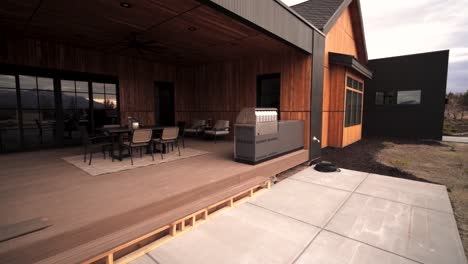 Panning-reveal-of-a-backyard-patio-deck-of-a-luxury-country-cottage