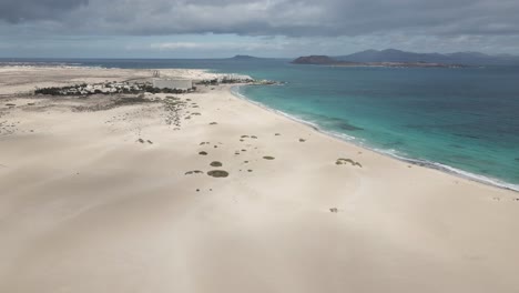 drone flight throw the coast of fuerteventura with mountains in backround and the atlantic ocean