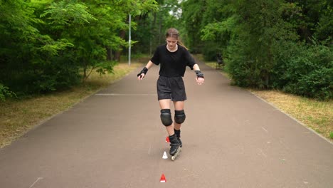 teenage girl roller skating and practicing on cones in the park