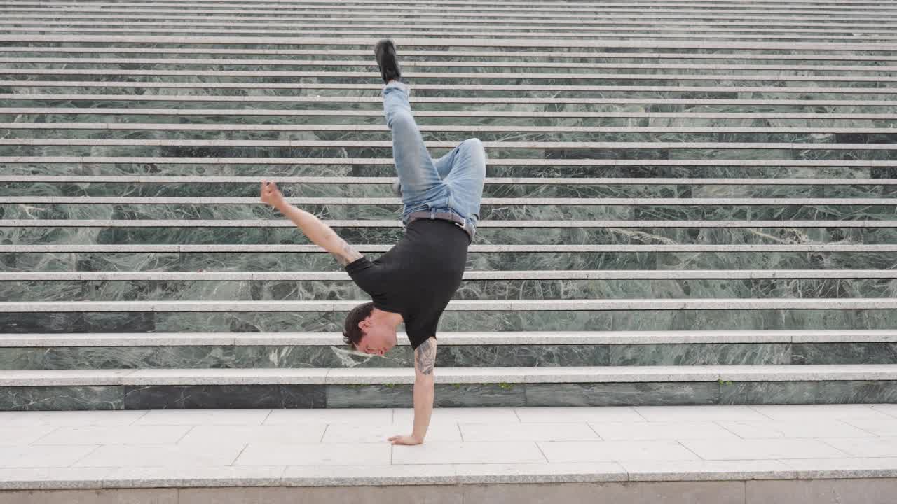 Breakdancer performing cartwheels on urban stairs
