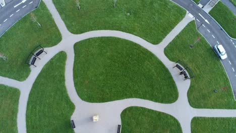 circular design aerial view above ornamental walkway cemetery garden with parking around outside