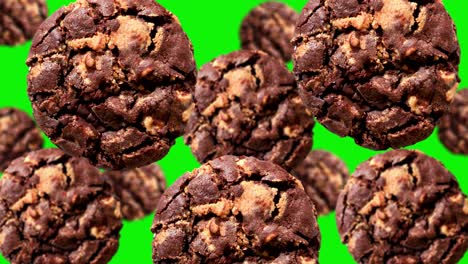 galleta de chocolate oscuro voladora de diferentes diámetros en la pantalla verde en un fondo aislado. patrón de fondo en movimiento. fondo animado. imágenes de dulces de navidad de alta calidad 4k
