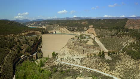 Drone-view-of-dam-with-road-closing-reservoir