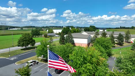 pennsylvania and american flag waving in rural pa at local government building