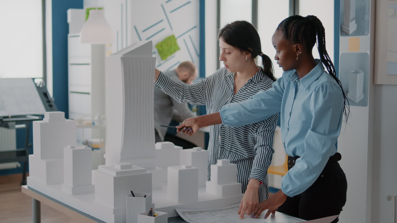 Architects Discussing Building Design with Architectural Model