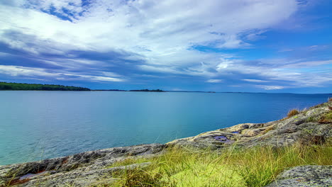 Timelapse-of-Serene-Attersee-Lake-landscape-with-grassy-shore