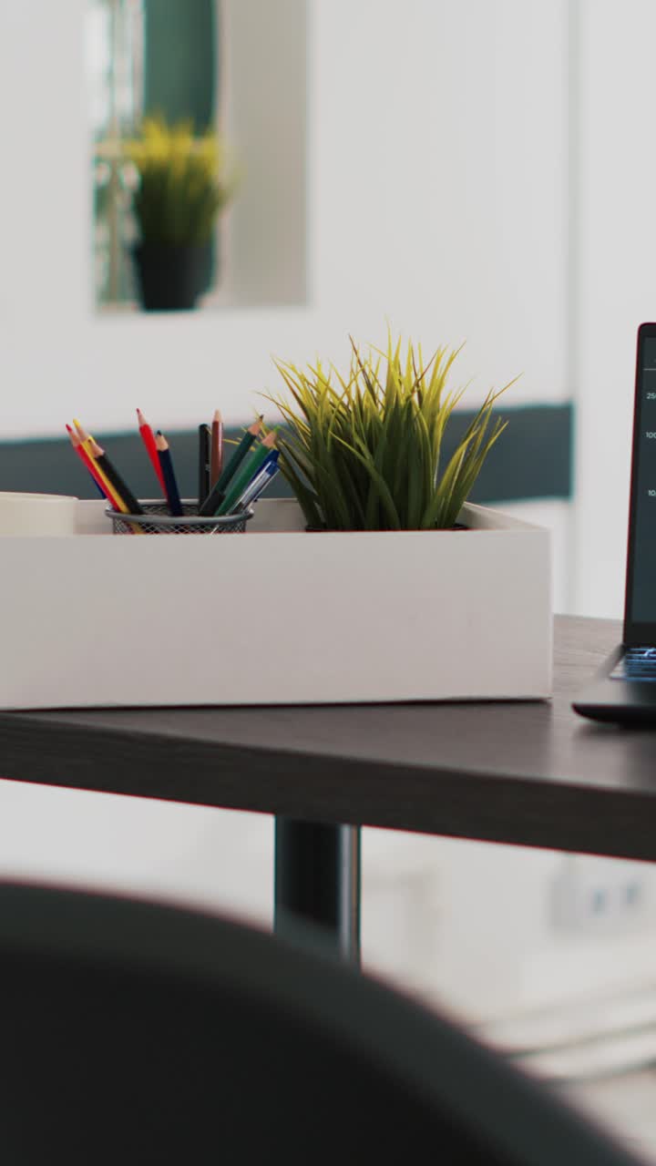 Vertical video Business forecasting graphs on laptop sitting on workspace desk