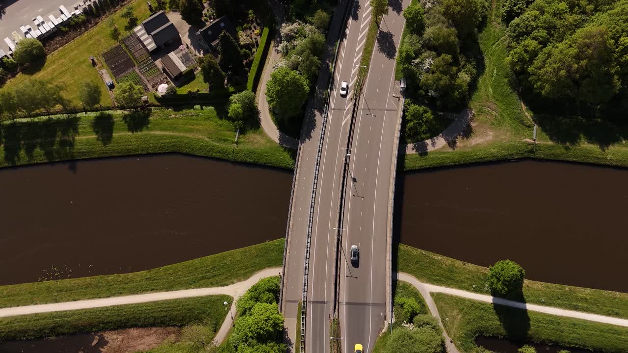 Aerial view of a bridge over a canal in a Dutch village.