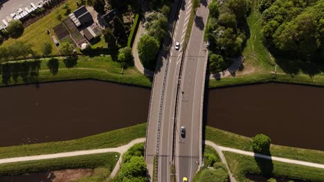 aerial view of a bridge over a canal in a dutch village.