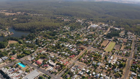 cinematic aerial shot of daylesford city, the natural lake and the famous great dividing range in background