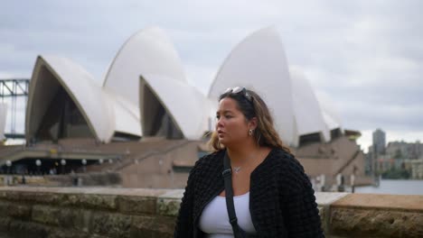 women standing in front of the sydney opera house