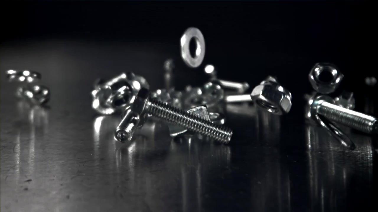 Metal Bolts, Nuts, and Washers Falling in Slow Motion