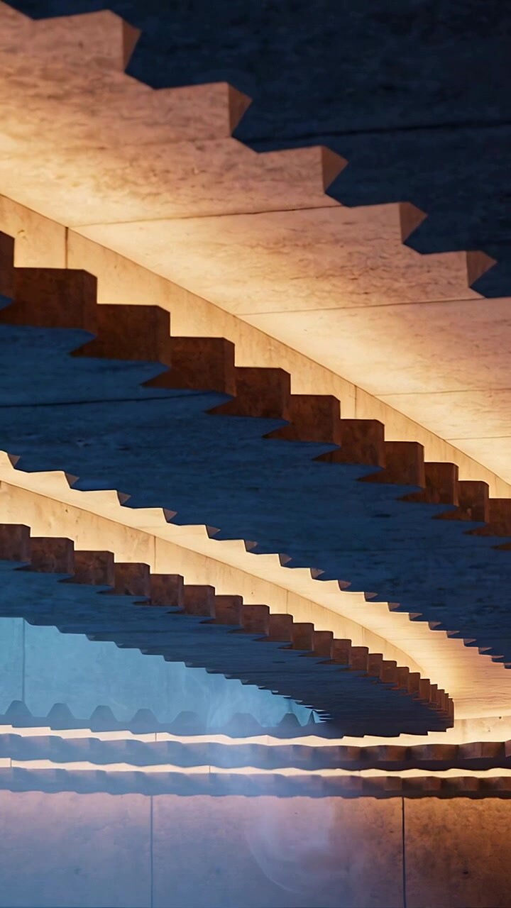 Vertical video: Panning camera showing layered concrete ribs in atrium, with LED strip, mirror band