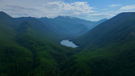 scenic view of forested mountains surrounded on the flathead lake in montana, united states