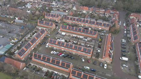 aerial overview of suburban neighborhood with solar panels on rooftops