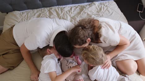 a loving family laughing happily with their precious newborn baby a joyful and affectionate family shares laughter and happiness while cherishing precious moments with their newborn baby