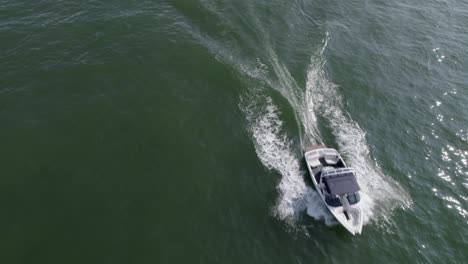 aerial view of a boat speeding past on the lake