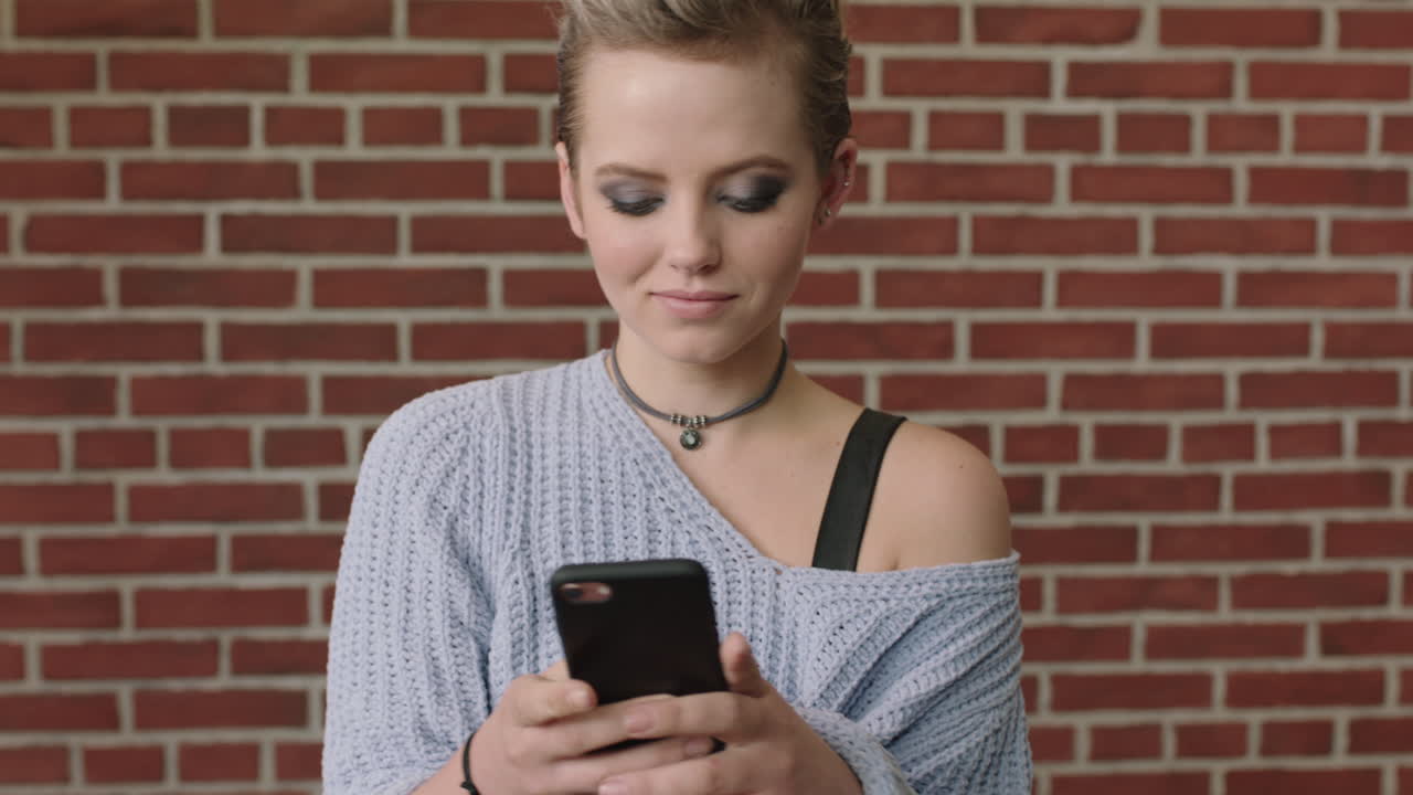 ritratto di moda di una giovane donna elegante che posa prendendo una foto selfie usando uno smartphone facendo facce