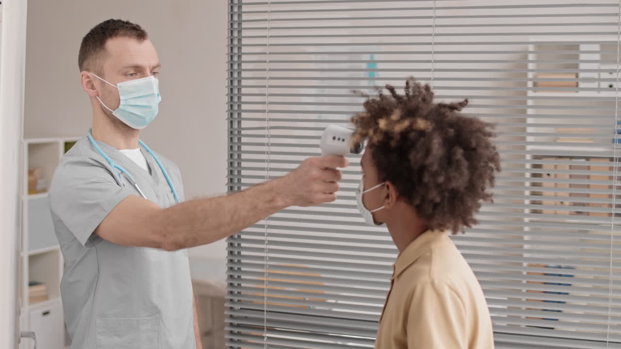 Doctor Checking Body Temperature of Patient