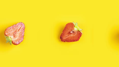 many red fresh cut strawberry animated on a yellow background.