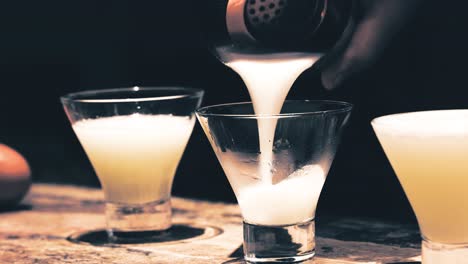 preparing a pisco sour in cusco, peru