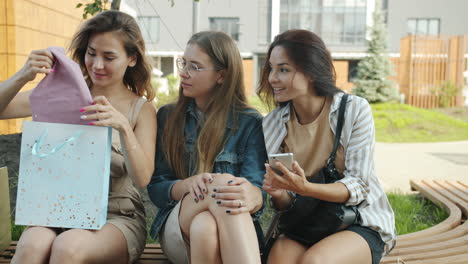 Three women shopping and laughing outdoors