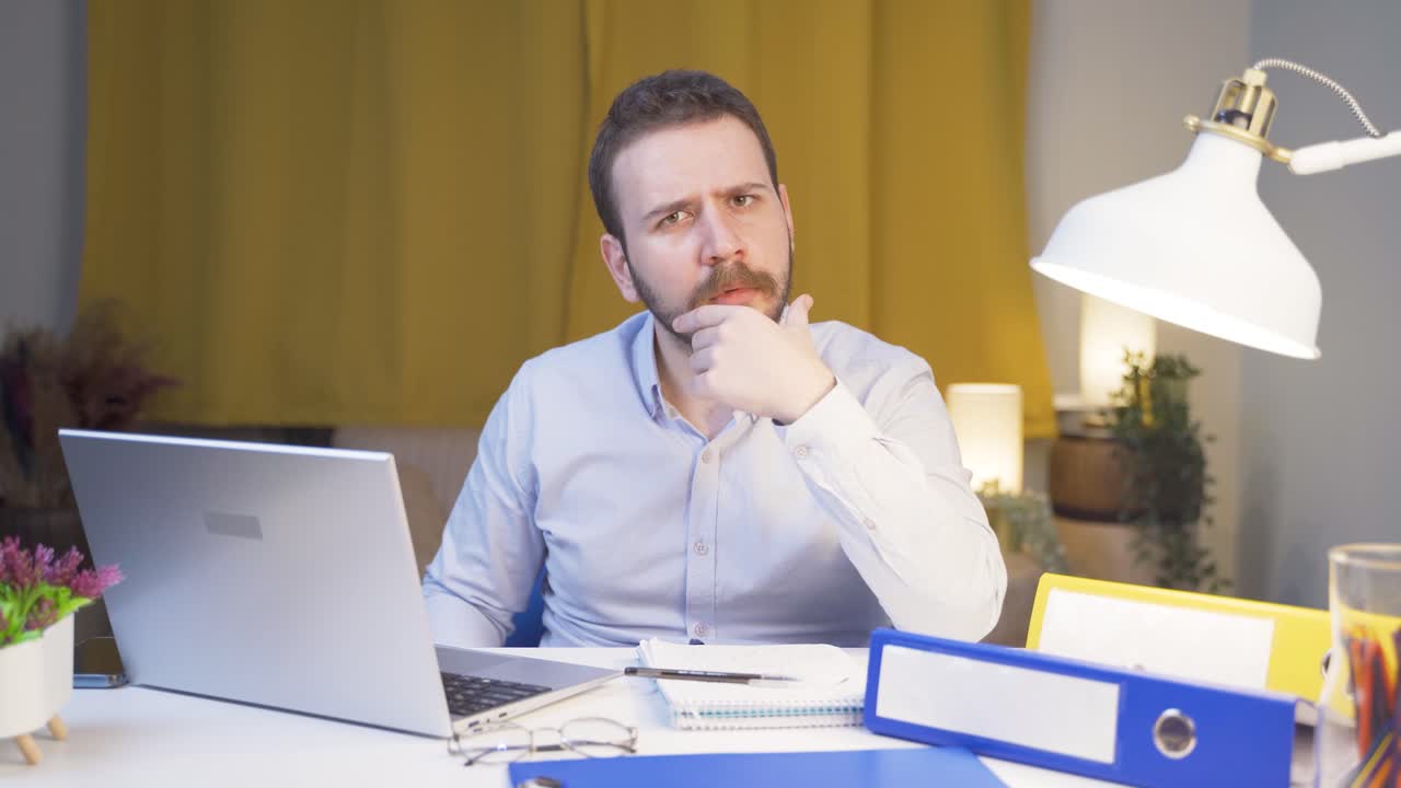 trabajador de oficina en casa mirando a la cámara curioso y confundido.
