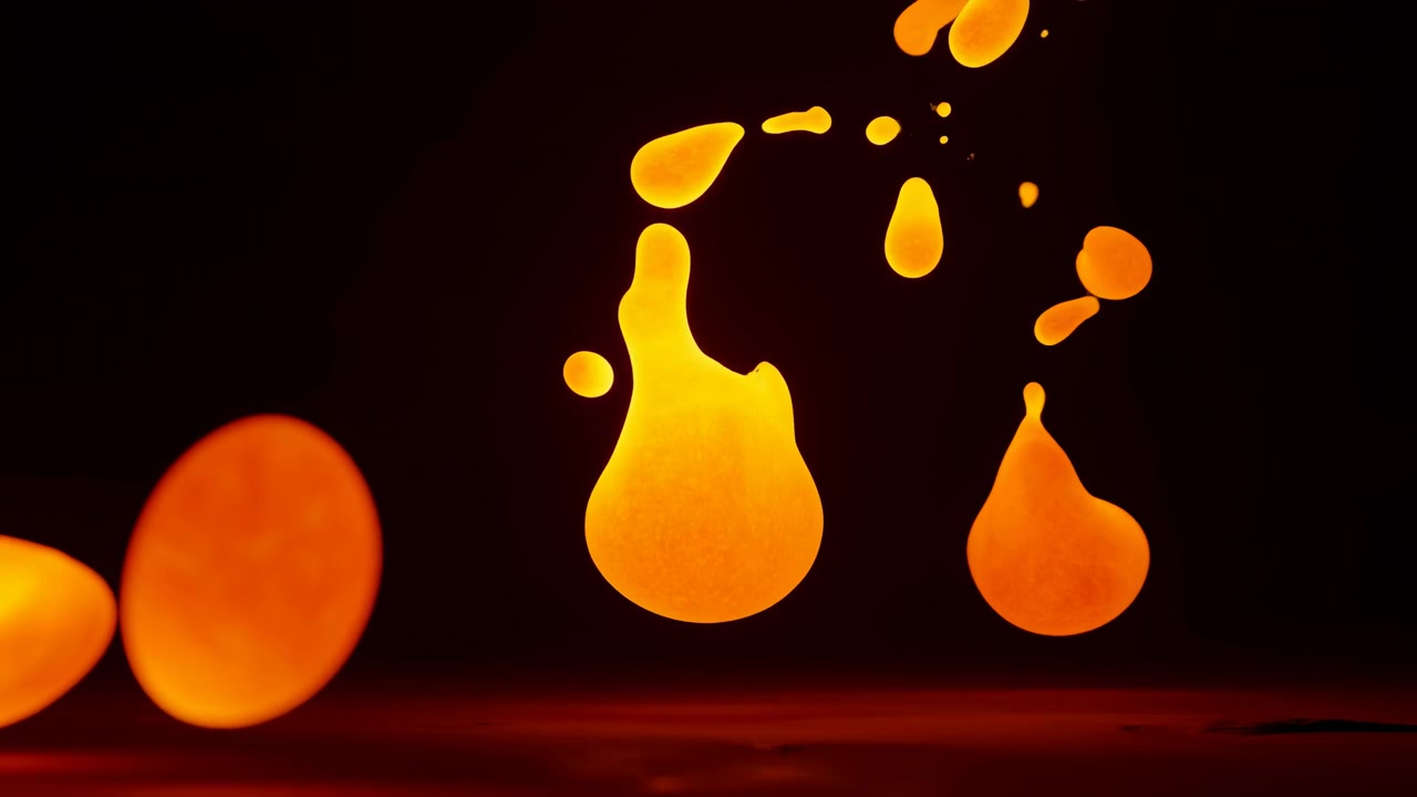 Nærbillede af glødende orange og gule væskedråber og tåreformede stænk, der svæver over en blank bordplade, hvilket skaber levende opdeling, spredning, refleksion og varm kontrast mod
