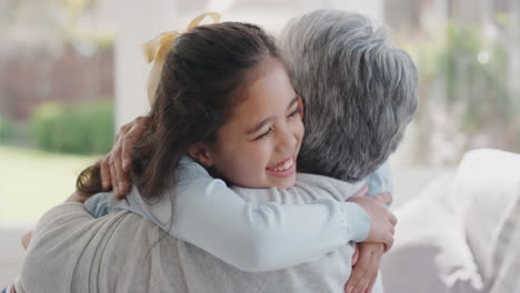 happy girl greeting grandmother with hug granny smiling embracing her granddaughter enjoying hug from grandchild at home family concept 4k