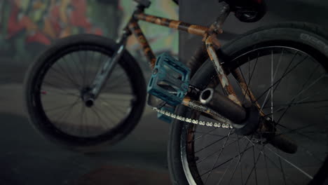 casual bmx bike standing along at skate park. bicycle wheels at skatepark.