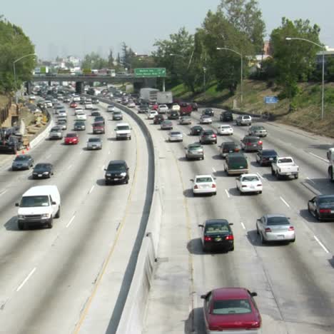 heavy traffic moves in opposite directions along a four lane freeway in los angeles