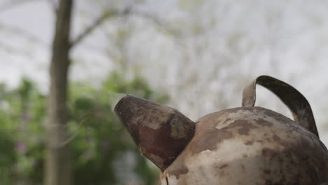 Close-up-of-a-bee-smoker-with-smoke-rising-from-it