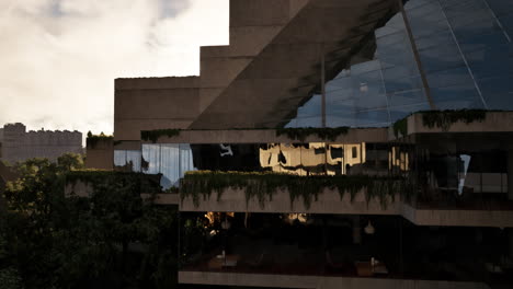 overgrown modern building at sunset