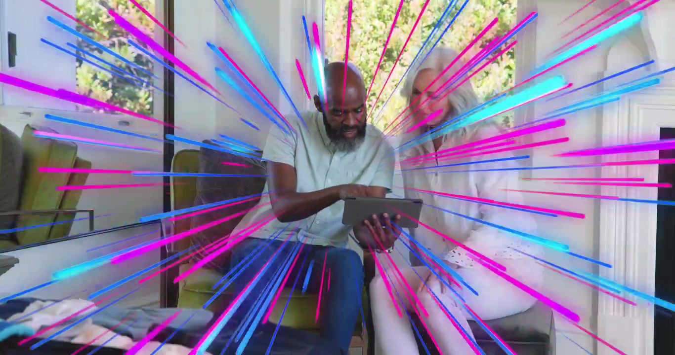 man sharing tech demo tapping tablet as woman leaning in with radial burst highlighting interaction