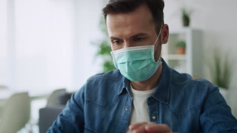 Zoom-out-video-of-satisfied-man-working-at-home