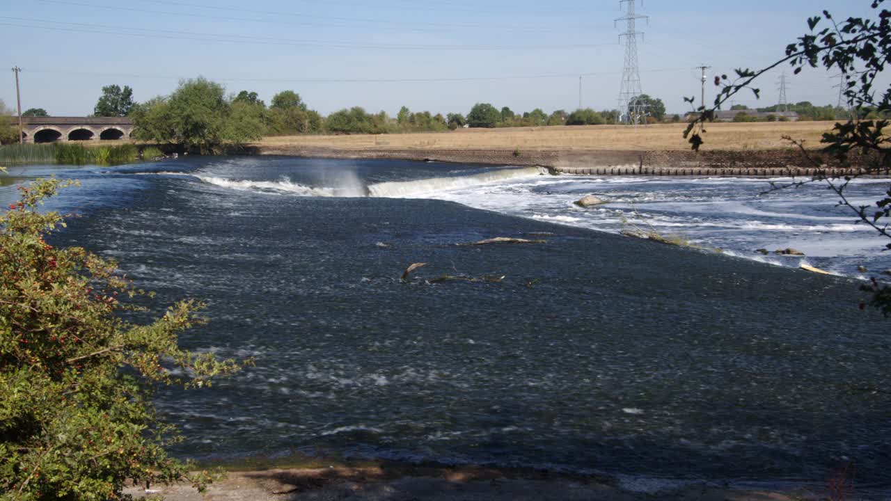 Side shot of water going over the River Trent weir by Ratcliffe on Soar Power station. Wide shot